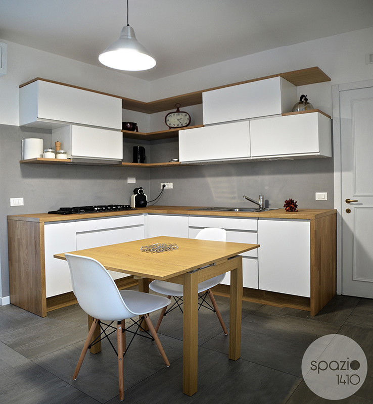 Mittelgroße Moderne Wohnküche ohne Insel in L-Form mit weißen Schränken, Küchenrückwand in Grau und Keramikboden in Rom