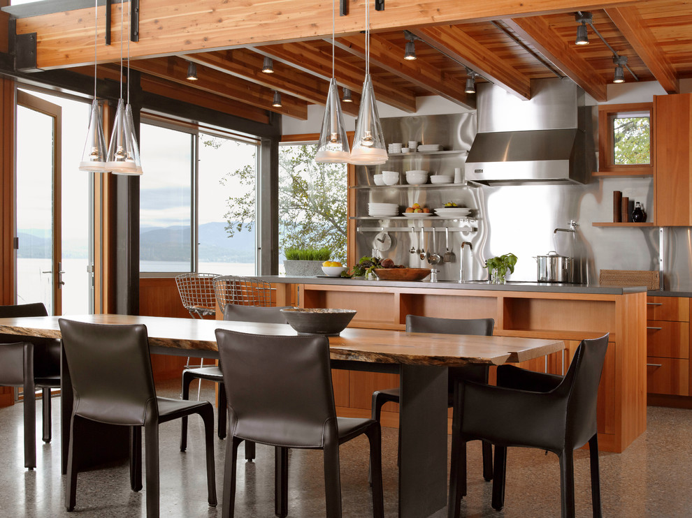 Eat-in kitchen - large modern galley eat-in kitchen idea in San Francisco with stainless steel appliances, medium tone wood cabinets and an island