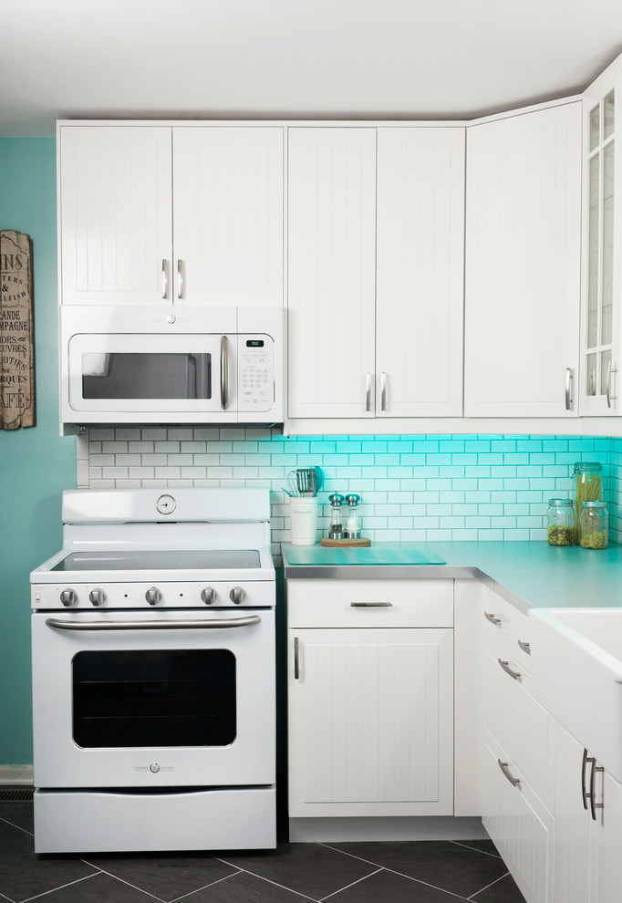 Example of a mid-sized eclectic u-shaped ceramic tile enclosed kitchen design in Nashville with a farmhouse sink, beaded inset cabinets, white cabinets, laminate countertops, white backsplash, subway tile backsplash and white appliances