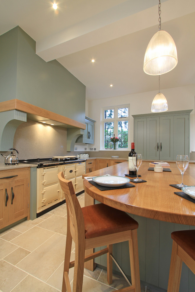 Classic l-shaped kitchen/diner in Hampshire with a double-bowl sink, shaker cabinets, light wood cabinets, engineered stone countertops, stone slab splashback and white appliances.