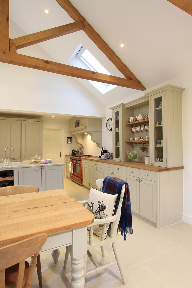 Inspiration for a large traditional l-shaped kitchen/diner in Hampshire with a belfast sink, shaker cabinets, grey cabinets, granite worktops, ceramic splashback, coloured appliances, porcelain flooring and an island.