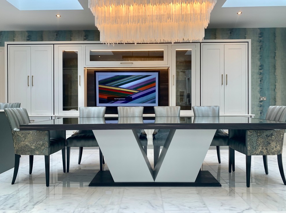Example of a large eclectic marble floor open concept kitchen design in Other with an integrated sink, black appliances and an island