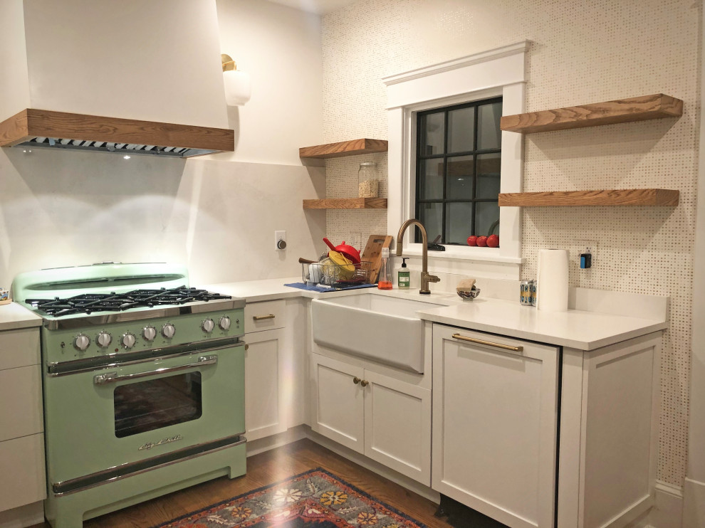 Small classic u-shaped kitchen in Atlanta with a belfast sink, shaker cabinets, white cabinets, engineered stone countertops, coloured appliances, medium hardwood flooring and brown floors.