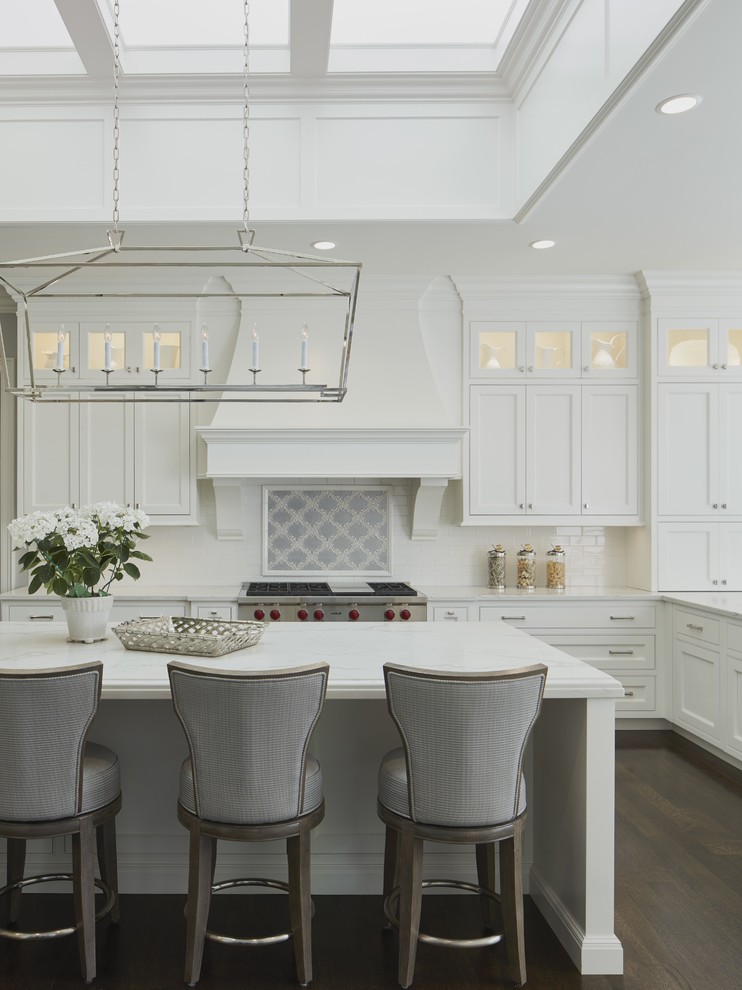 This is an example of a traditional kitchen in Chicago with recessed-panel cabinets, white cabinets and engineered stone countertops.