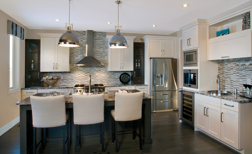 Inspiration for a traditional kitchen in Calgary with recessed-panel cabinets, white cabinets and stainless steel appliances.