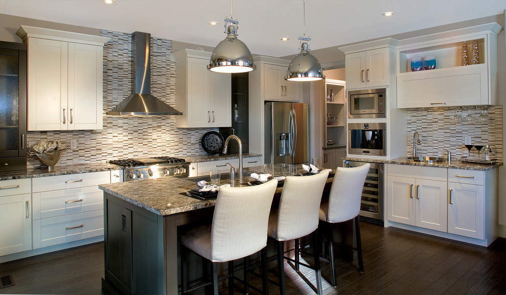This is an example of a traditional kitchen in Calgary with recessed-panel cabinets, white cabinets and stainless steel appliances.