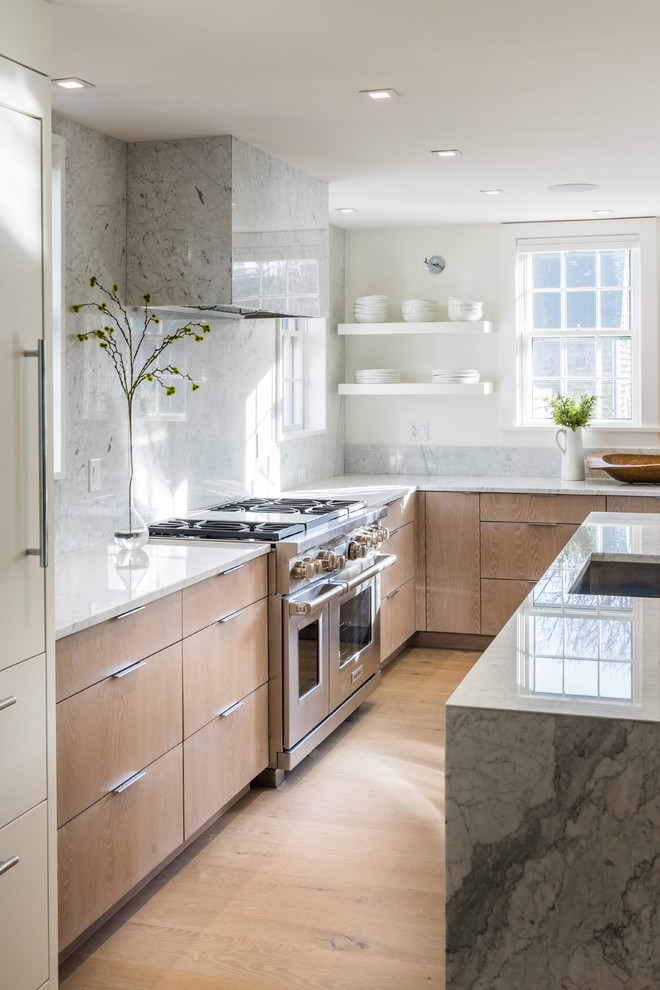 Mid-sized trendy l-shaped light wood floor eat-in kitchen photo in Boston with a single-bowl sink, flat-panel cabinets, light wood cabinets, marble countertops, white backsplash, marble backsplash, paneled appliances, an island and white countertops