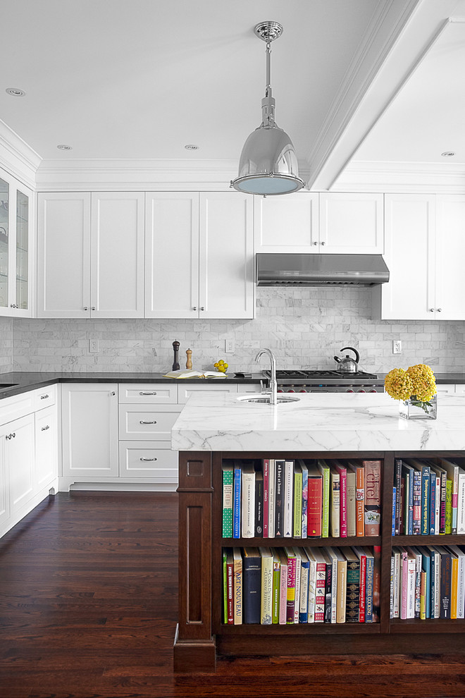 Large elegant l-shaped dark wood floor eat-in kitchen photo in Toronto with recessed-panel cabinets, white cabinets, marble countertops, stone tile backsplash, gray backsplash, an undermount sink, stainless steel appliances and an island