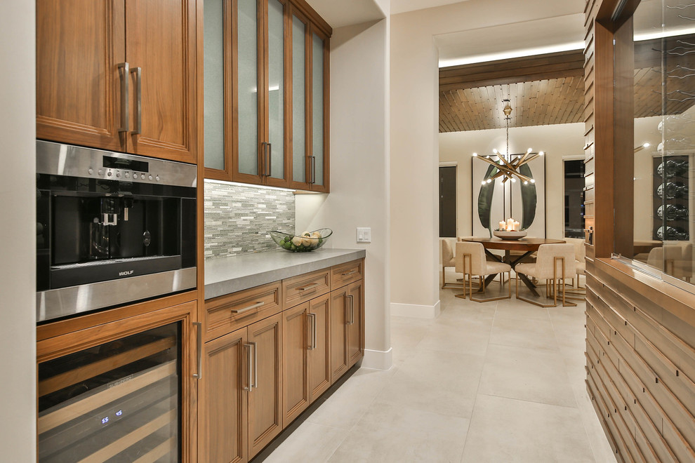 Open concept kitchen - mid-sized transitional u-shaped porcelain tile and beige floor open concept kitchen idea in Other with a double-bowl sink, recessed-panel cabinets, brown cabinets, quartzite countertops, blue backsplash, mosaic tile backsplash, stainless steel appliances and an island