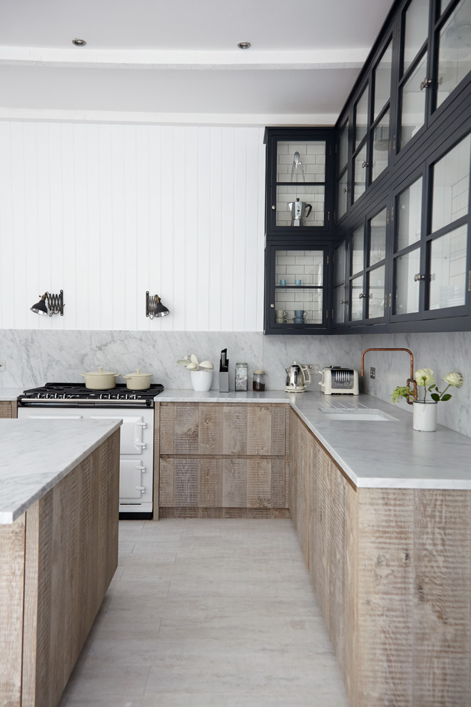 Danish kitchen photo in London with an undermount sink, glass-front cabinets, white appliances, an island and gray backsplash