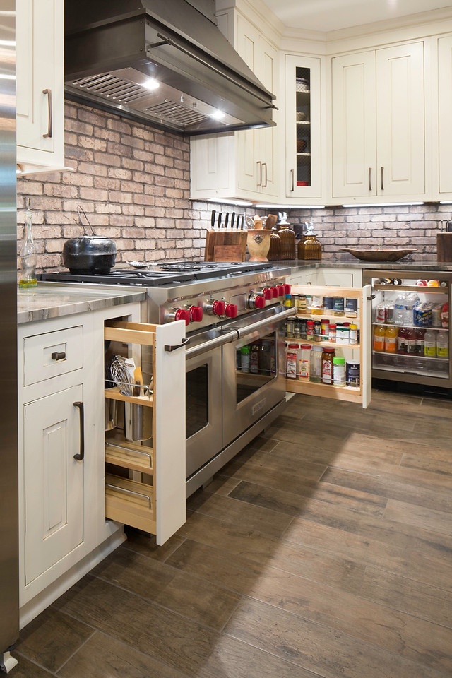 Example of a mid-sized urban kitchen pantry design in Atlanta with a farmhouse sink, beaded inset cabinets, quartzite countertops, brick backsplash, stainless steel appliances and an island