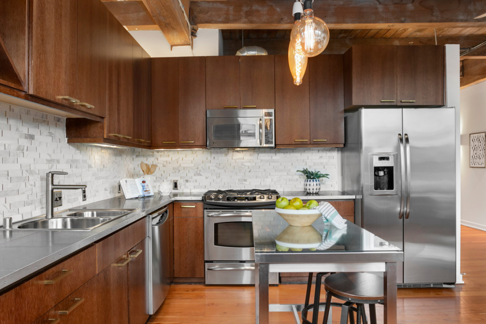 Photo of a small urban l-shaped kitchen/diner in Seattle with a double-bowl sink, flat-panel cabinets, dark wood cabinets, white splashback, ceramic splashback, stainless steel appliances, medium hardwood flooring, an island, brown floors, grey worktops and a wood ceiling.