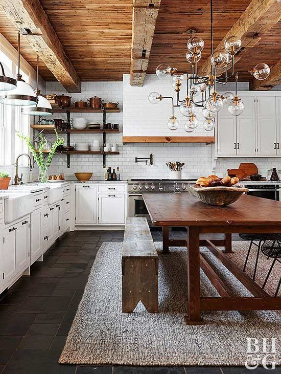 Exemple d'une cuisine américaine industrielle en L de taille moyenne avec un évier de ferme, un placard avec porte à panneau encastré, des portes de placard blanches, un plan de travail en quartz modifié, une crédence blanche, une crédence en carrelage métro, un électroménager en acier inoxydable, un sol en ardoise, îlot, un sol gris et un plan de travail blanc.