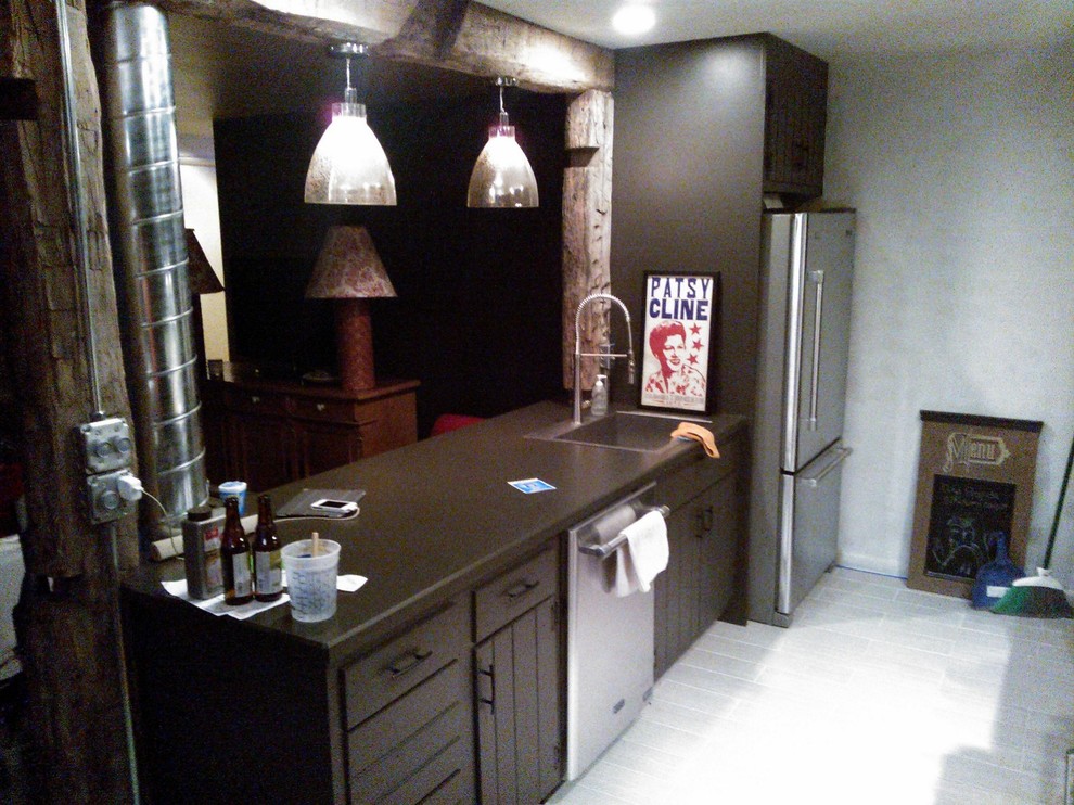 Photo of a large industrial u-shaped kitchen/diner in Indianapolis with a belfast sink, louvered cabinets, dark wood cabinets, granite worktops, grey splashback, stone tiled splashback, stainless steel appliances, ceramic flooring and a breakfast bar.