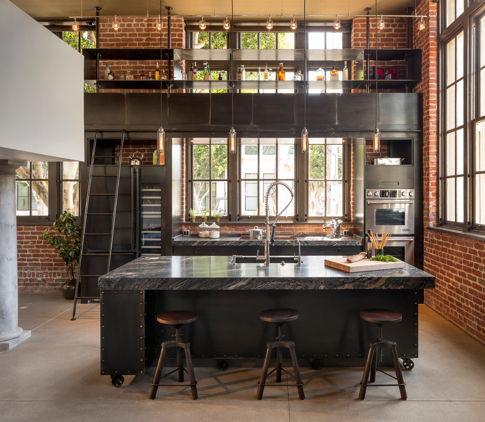 Urban galley concrete floor eat-in kitchen photo in Other with flat-panel cabinets, stainless steel appliances and an island