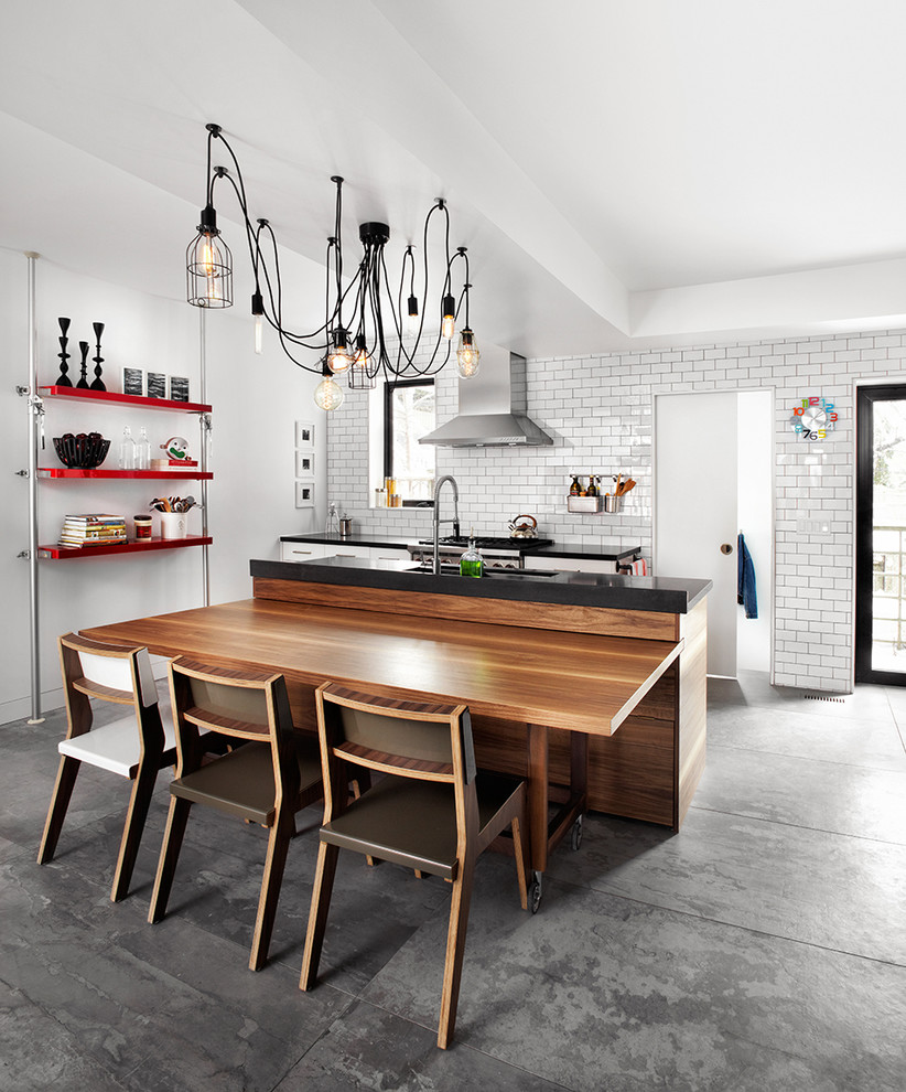 Urban galley eat-in kitchen photo in Toronto with flat-panel cabinets, white cabinets, white backsplash, subway tile backsplash and an island