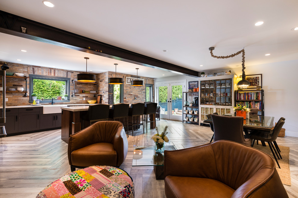 Large urban l-shaped open plan kitchen in Vancouver with a submerged sink, shaker cabinets, grey cabinets, engineered stone countertops, brown splashback, brick splashback, stainless steel appliances, porcelain flooring, an island and beige floors.