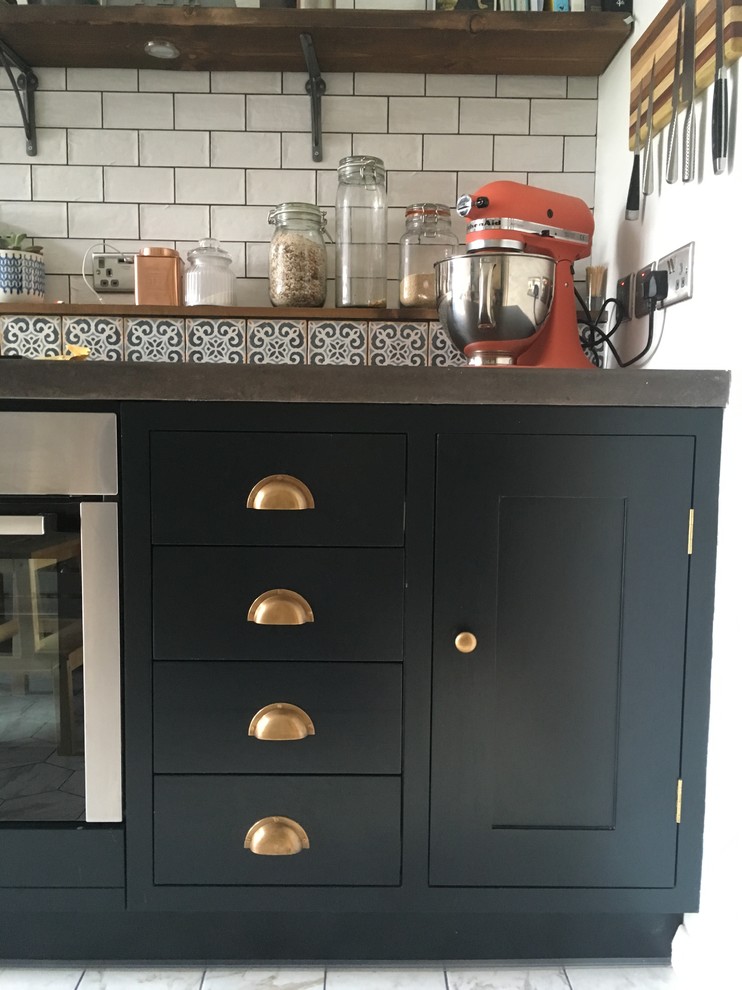 This is an example of a medium sized industrial galley kitchen/diner in Other with a submerged sink, shaker cabinets, blue cabinets, concrete worktops, white splashback, metro tiled splashback, stainless steel appliances, porcelain flooring and no island.