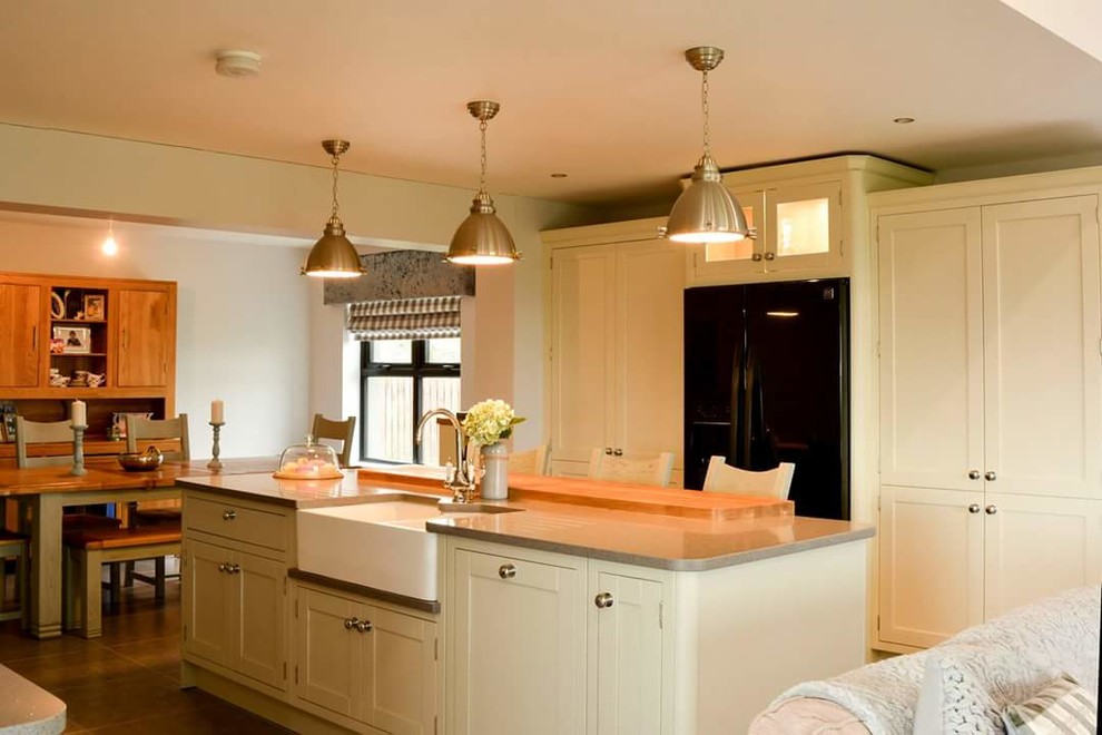 Photo of a contemporary kitchen in Other with a belfast sink, quartz worktops and an island.