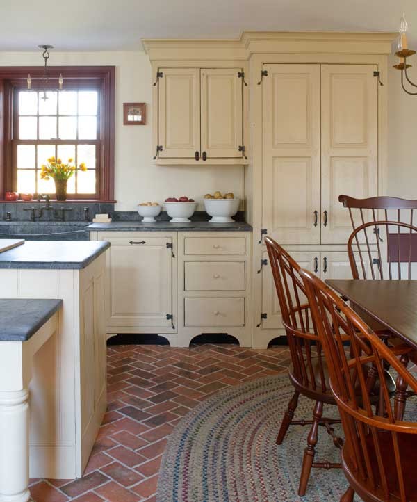 Classic grey and cream kitchen in Philadelphia with brick flooring.