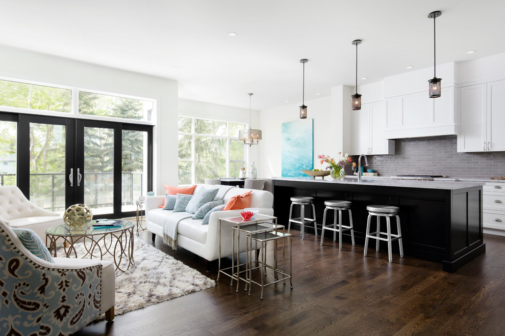 Huge transitional galley dark wood floor open concept kitchen photo in Calgary with an undermount sink, shaker cabinets, white cabinets, quartzite countertops, gray backsplash, subway tile backsplash, stainless steel appliances and an island