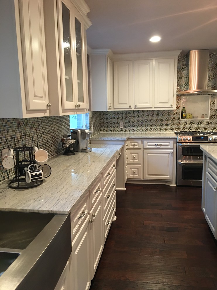 Inspiration for a huge modern l-shaped dark wood floor and brown floor kitchen pantry remodel in Houston with a farmhouse sink, raised-panel cabinets, purple cabinets, granite countertops, glass tile backsplash, stainless steel appliances and an island