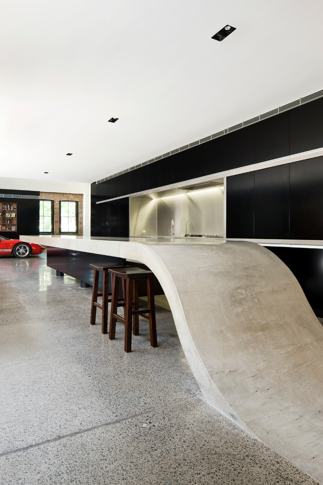 Large contemporary galley kitchen/diner in Sydney with flat-panel cabinets, black cabinets, metal splashback and an island.