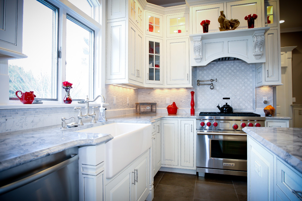 Bild på ett vintage u-kök, med luckor med profilerade fronter, vita skåp, granitbänkskiva, vitt stänkskydd, rostfria vitvaror och stänkskydd i stenkakel