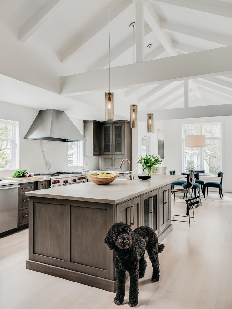 Large transitional u-shaped light wood floor and beige floor eat-in kitchen photo in San Francisco with recessed-panel cabinets, concrete countertops, white backsplash, stone slab backsplash, stainless steel appliances, an island, a farmhouse sink, gray cabinets and multicolored countertops