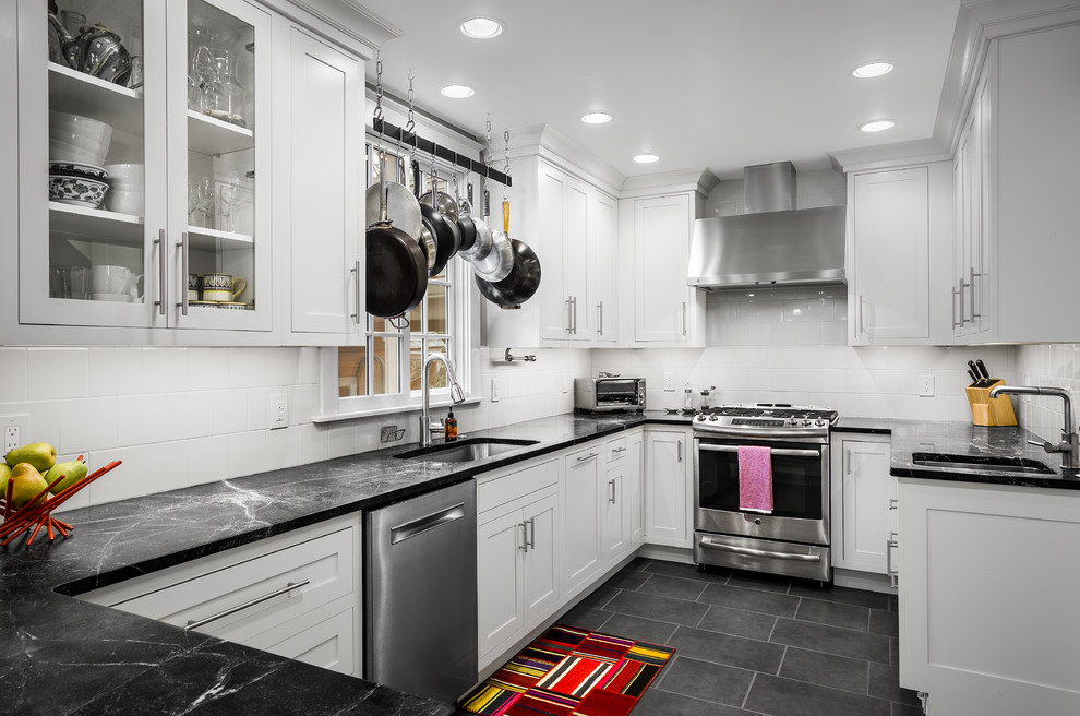 Inspiration for a small transitional u-shaped porcelain tile eat-in kitchen remodel in Philadelphia with an undermount sink, white cabinets, soapstone countertops, white backsplash, glass tile backsplash, stainless steel appliances, a peninsula and shaker cabinets