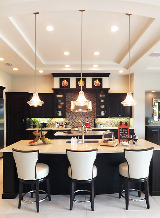 Example of a huge transitional l-shaped ceramic tile eat-in kitchen design in Tampa with an undermount sink, recessed-panel cabinets, black cabinets, onyx countertops, metallic backsplash, matchstick tile backsplash, stainless steel appliances and two islands