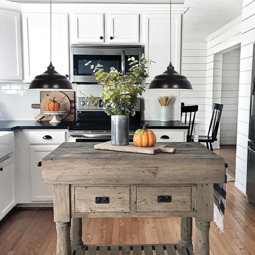 Inspiration for a mid-sized farmhouse eat-in kitchen remodel in Houston with flat-panel cabinets, an island and white countertops