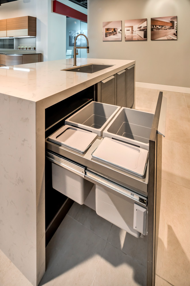 Design ideas for a medium sized contemporary l-shaped kitchen pantry in San Francisco with a single-bowl sink, flat-panel cabinets, dark wood cabinets, engineered stone countertops, grey splashback, porcelain splashback, porcelain flooring and an island.