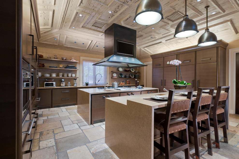 This is an example of a large traditional enclosed kitchen in Miami with a submerged sink, flat-panel cabinets, medium wood cabinets, beige splashback, stone slab splashback, integrated appliances, limestone flooring and multiple islands.