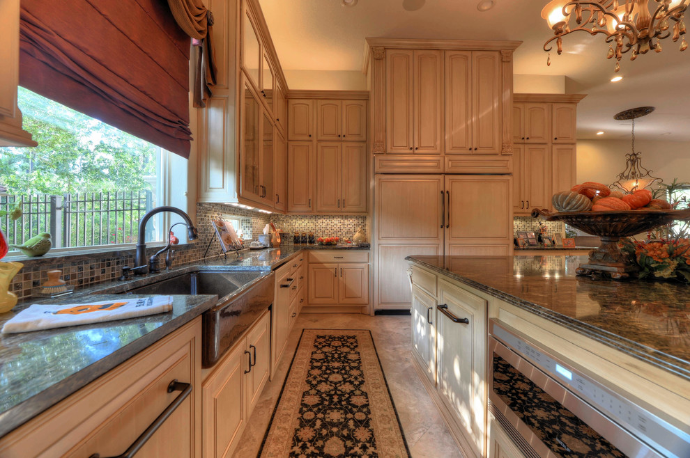 Example of a classic l-shaped kitchen design in Houston with a farmhouse sink, raised-panel cabinets, medium tone wood cabinets, multicolored backsplash, mosaic tile backsplash, paneled appliances and an island