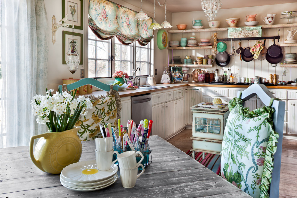 Cottage chic kitchen photo in Kansas City with wood countertops