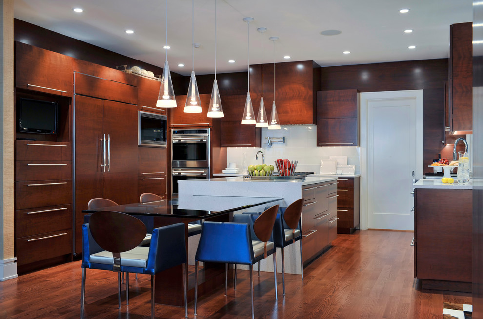 Inspiration for a contemporary u-shaped medium tone wood floor and brown floor kitchen remodel in Miami with flat-panel cabinets, dark wood cabinets, white backsplash, stainless steel appliances, an island and gray countertops