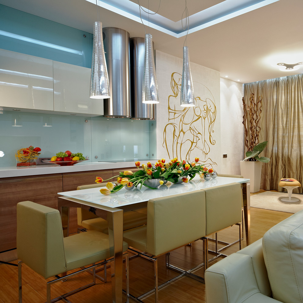 Example of a large trendy l-shaped bamboo floor eat-in kitchen design in New York with a single-bowl sink, glass-front cabinets, medium tone wood cabinets, quartz countertops, white backsplash, glass sheet backsplash, stainless steel appliances and no island