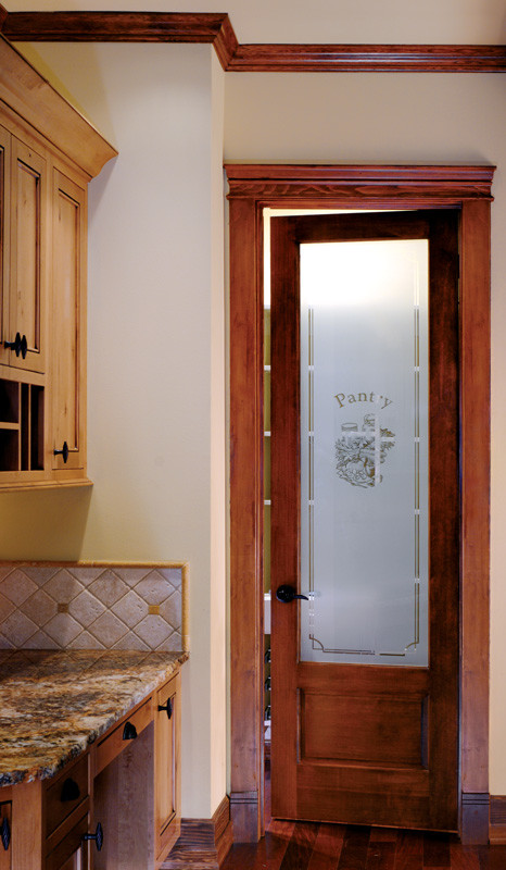 Foto de cocina de tamaño medio con armarios con paneles con relieve, encimera de acrílico y suelo de madera oscura