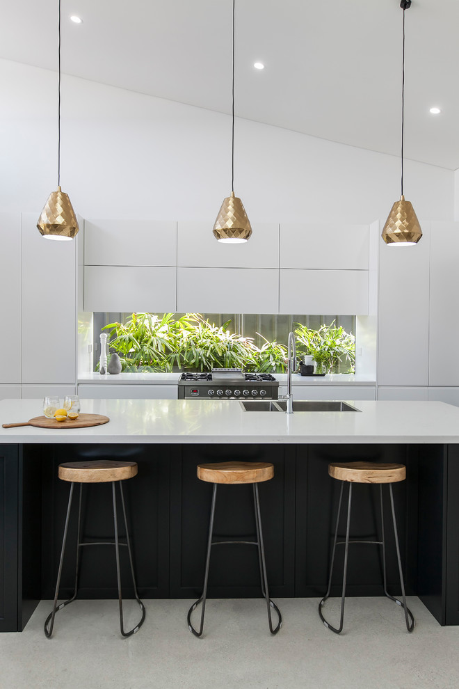 Photo of a medium sized contemporary kitchen in Wollongong with a built-in sink, flat-panel cabinets, stainless steel appliances and an island.