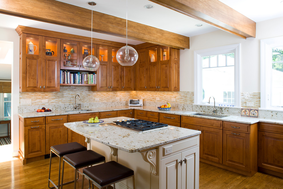 Elegant kitchen photo in Boston with an undermount sink, raised-panel cabinets, medium tone wood cabinets, beige backsplash and matchstick tile backsplash