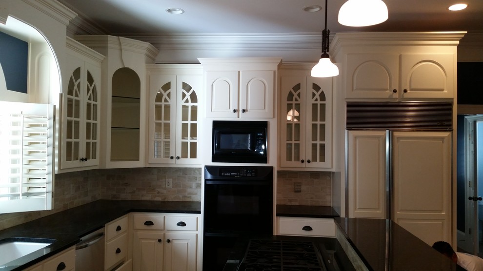 Example of a large l-shaped kitchen design in Atlanta with white cabinets