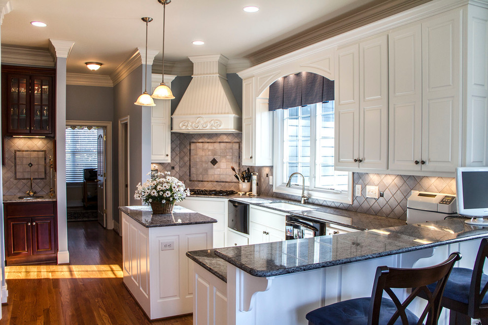 Inspiration for a mid-sized timeless u-shaped medium tone wood floor eat-in kitchen remodel in Richmond with a double-bowl sink, raised-panel cabinets, white cabinets, granite countertops, beige backsplash, stone tile backsplash, black appliances and an island