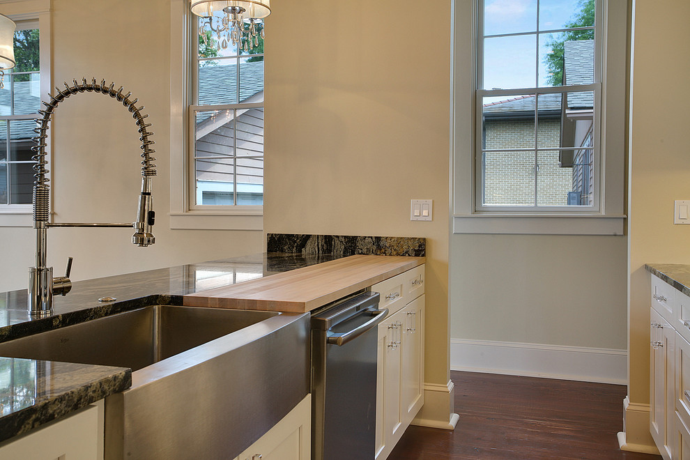 Kitchen - contemporary kitchen idea in New Orleans with a farmhouse sink and wood countertops