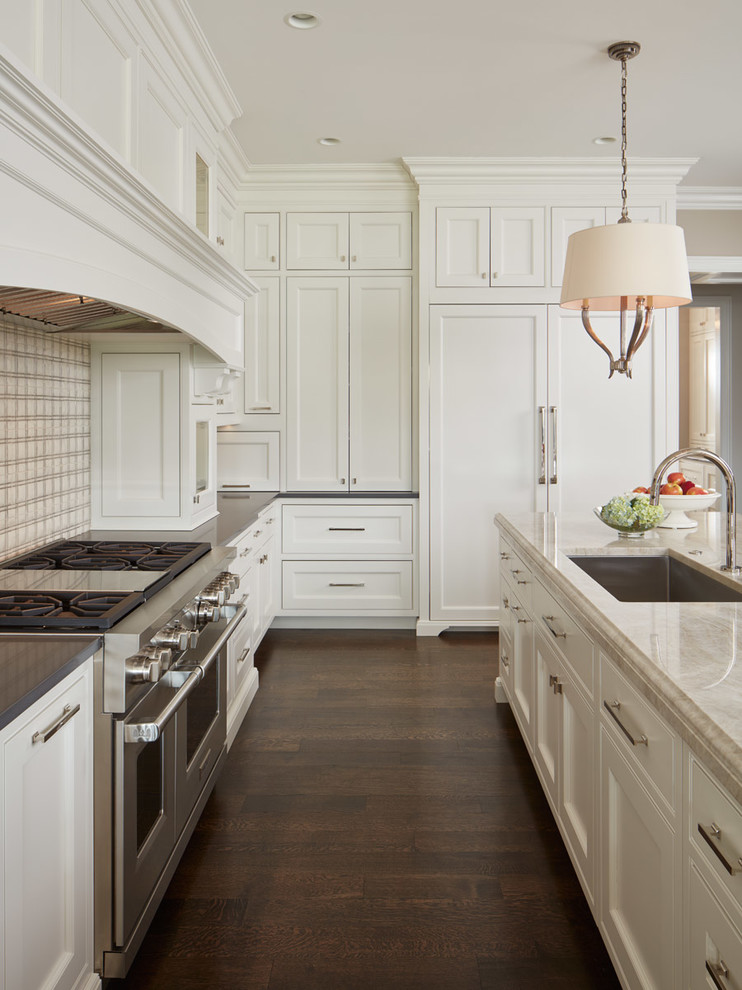 Inspiration for a kitchen in Chicago with multiple islands, a submerged sink, white cabinets and dark hardwood flooring.