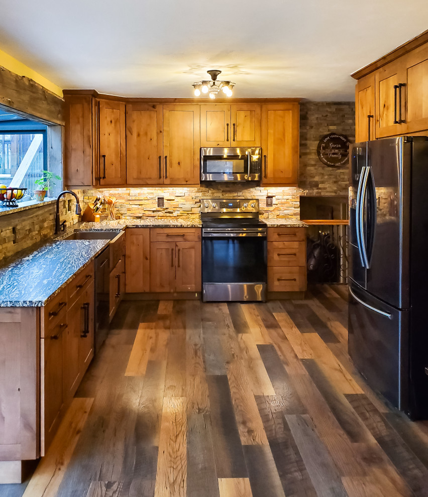 Eat-in kitchen - mid-sized rustic l-shaped brown floor and laminate floor eat-in kitchen idea in Chicago with a farmhouse sink, beige backsplash, stone tile backsplash, stainless steel appliances, medium tone wood cabinets, granite countertops and multicolored countertops