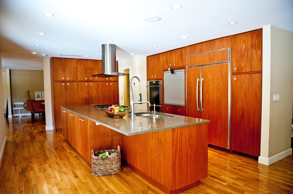 Example of a large transitional single-wall medium tone wood floor eat-in kitchen design in Miami with an undermount sink, flat-panel cabinets, dark wood cabinets, stainless steel appliances and an island