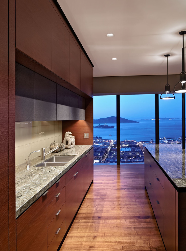 Minimalist kitchen photo in San Francisco with glass tile backsplash, a double-bowl sink, flat-panel cabinets, dark wood cabinets, white backsplash and granite countertops