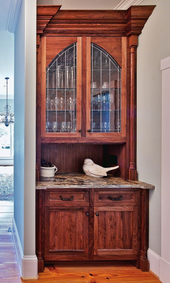 Mid-sized elegant medium tone wood floor kitchen photo in Orange County with dark wood cabinets