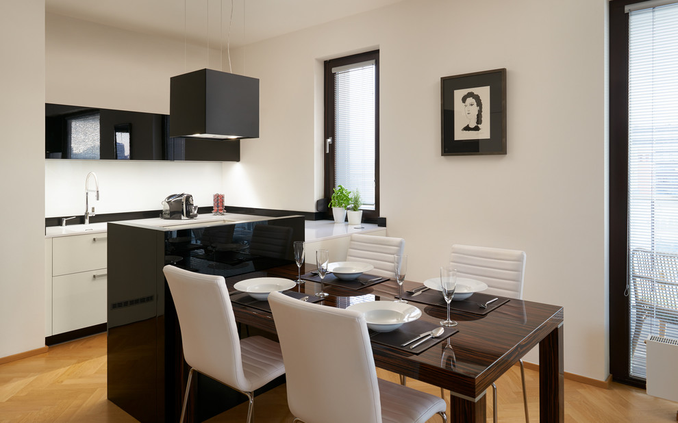 Mid-sized trendy light wood floor eat-in kitchen photo in Other with flat-panel cabinets, granite countertops, white backsplash, a peninsula and black cabinets